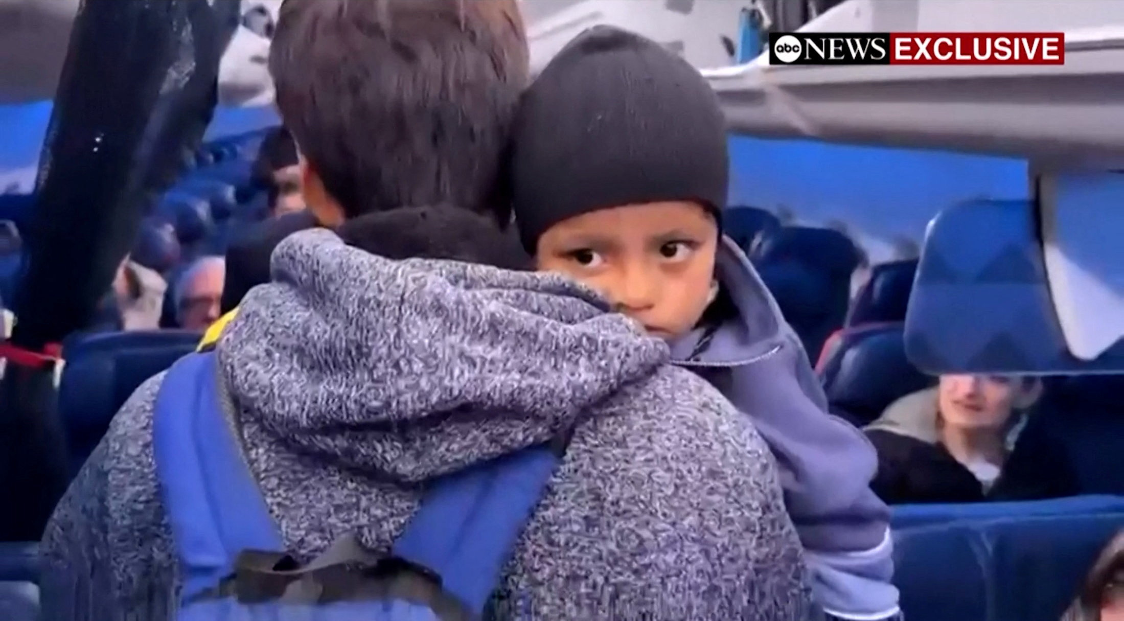 Liam Conejo Ramos is held by his father Adrian Alexander Conejo Arias while boarding an aircraft to return to Minneapolis