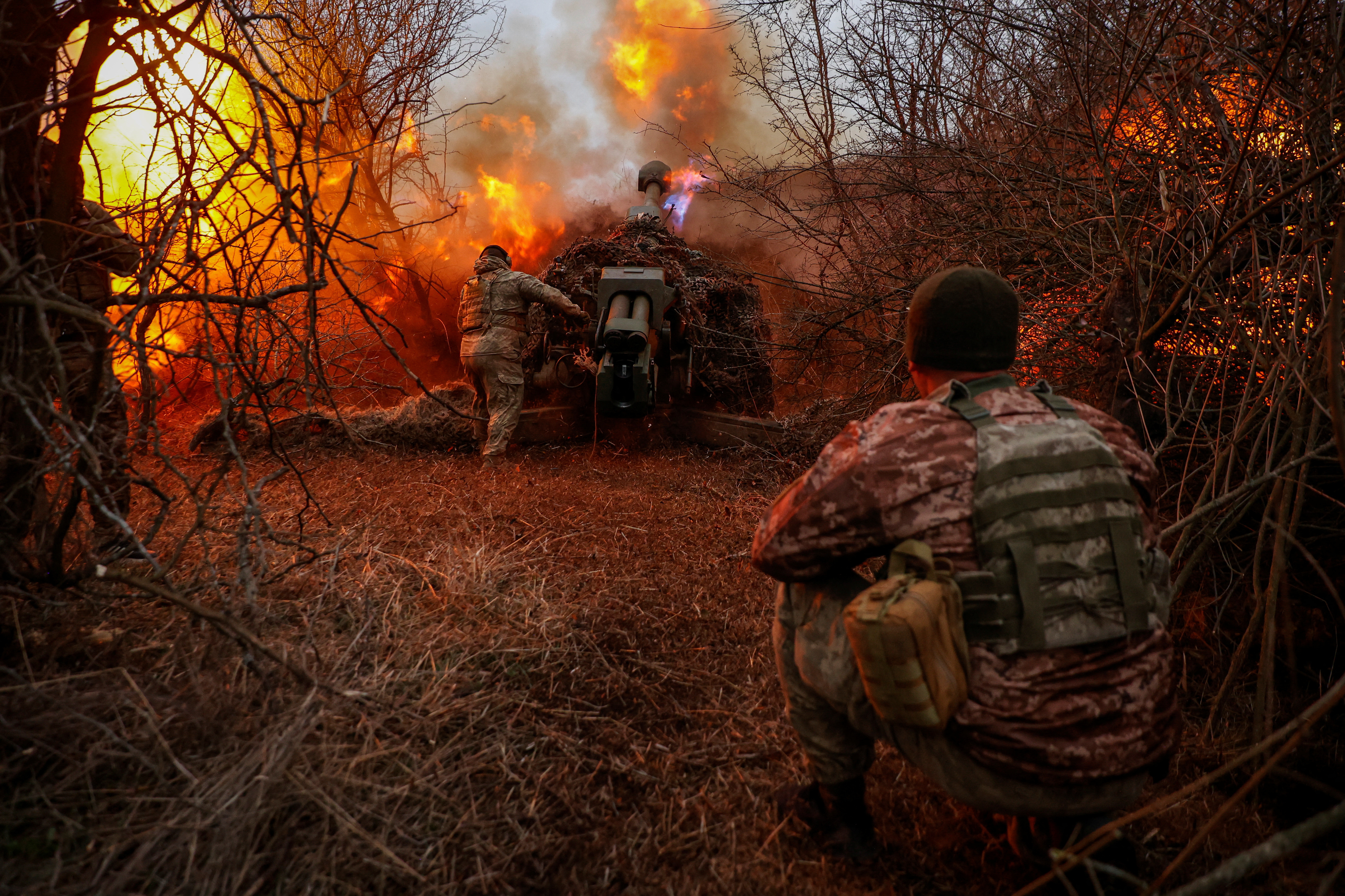Ukrainian serviceman fire a D-30 howitzer towards Russian troops at a position in a front line in Kherson region