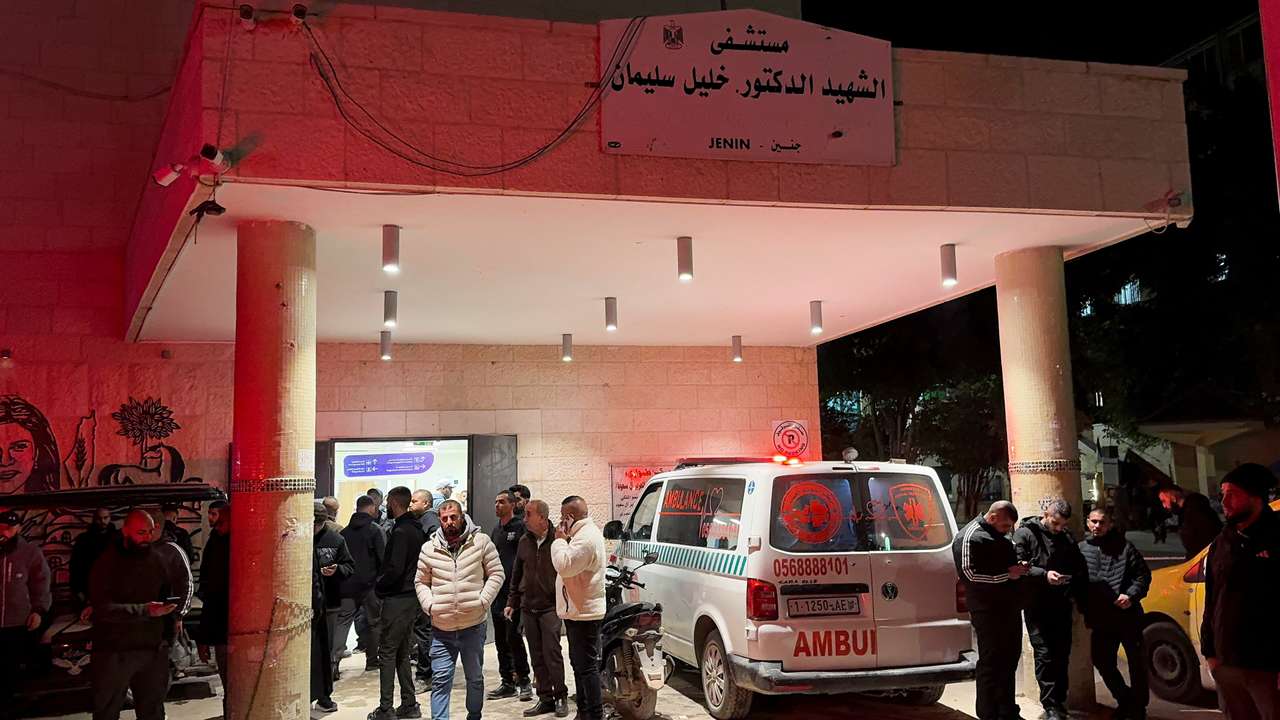 People gather in front of a hospital, after several Palestinians were killed in an Israeli strike, in Jenin