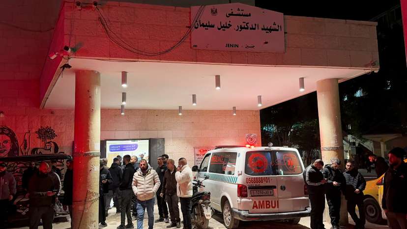 People gather in front of a hospital, after several Palestinians were killed in an Israeli strike, in Jenin