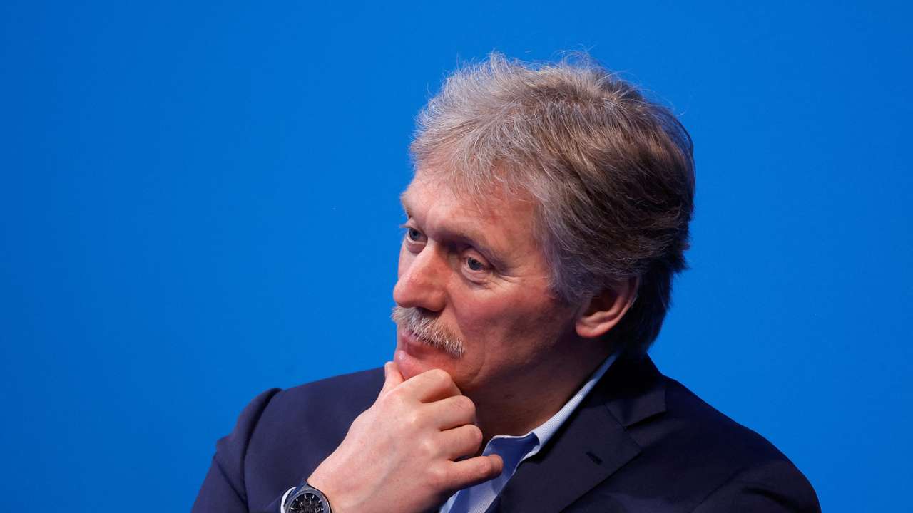 FILE PHOTO: Kremlin spokesman Peskov listens as Russian incumbent President Putin speaks, in Moscow