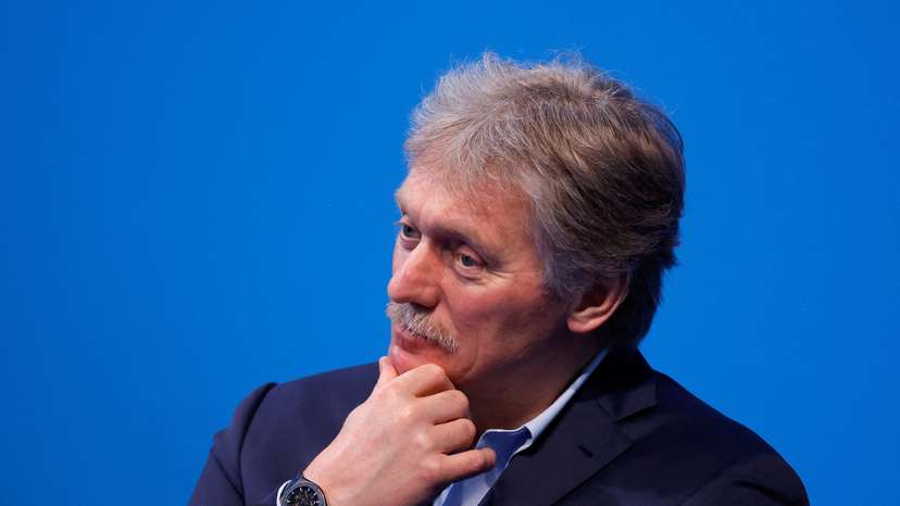 FILE PHOTO: Kremlin spokesman Peskov listens as Russian incumbent President Putin speaks, in Moscow