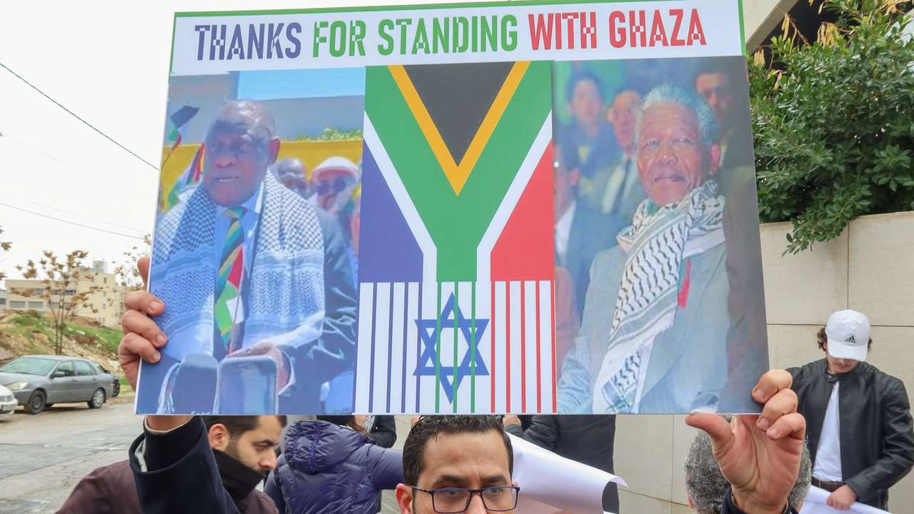 Demonstrators protest as judges at the ICJ in the Hague hear a request for emergency measures to order Israel to stop its military actions in Gaza, in Amman