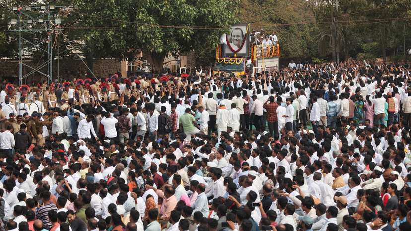People watch as the body of Maharashtra Deputy Chief Minister Ajit Pawar arrives during his funeral, after he was killed in a charter plane crash, in Baramati