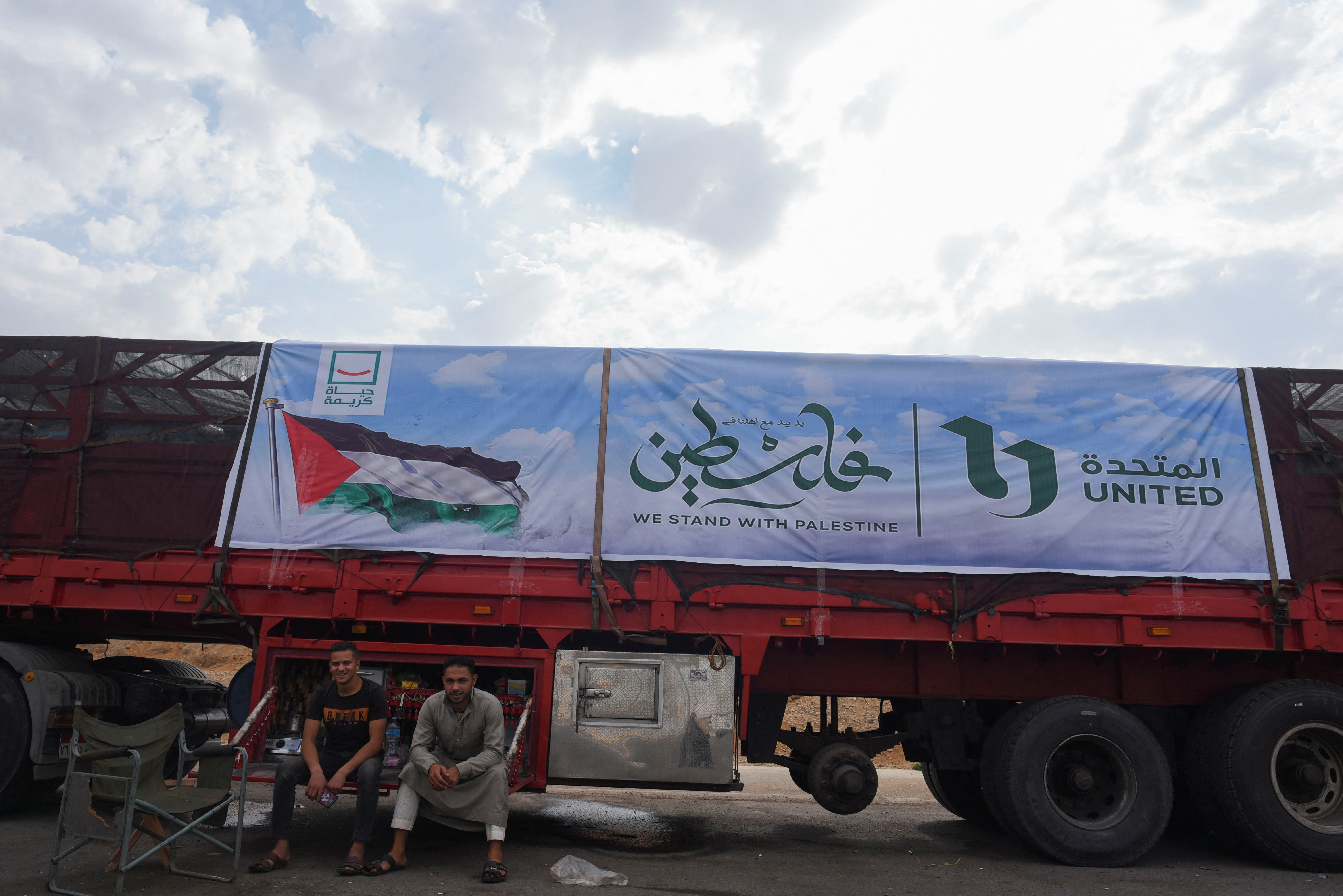 Trucks carrying humanitarian aid to Palestinians, wait on the desert road (Cairo - Ismailia) on their way to the Rafah border crossing to enter Gaza