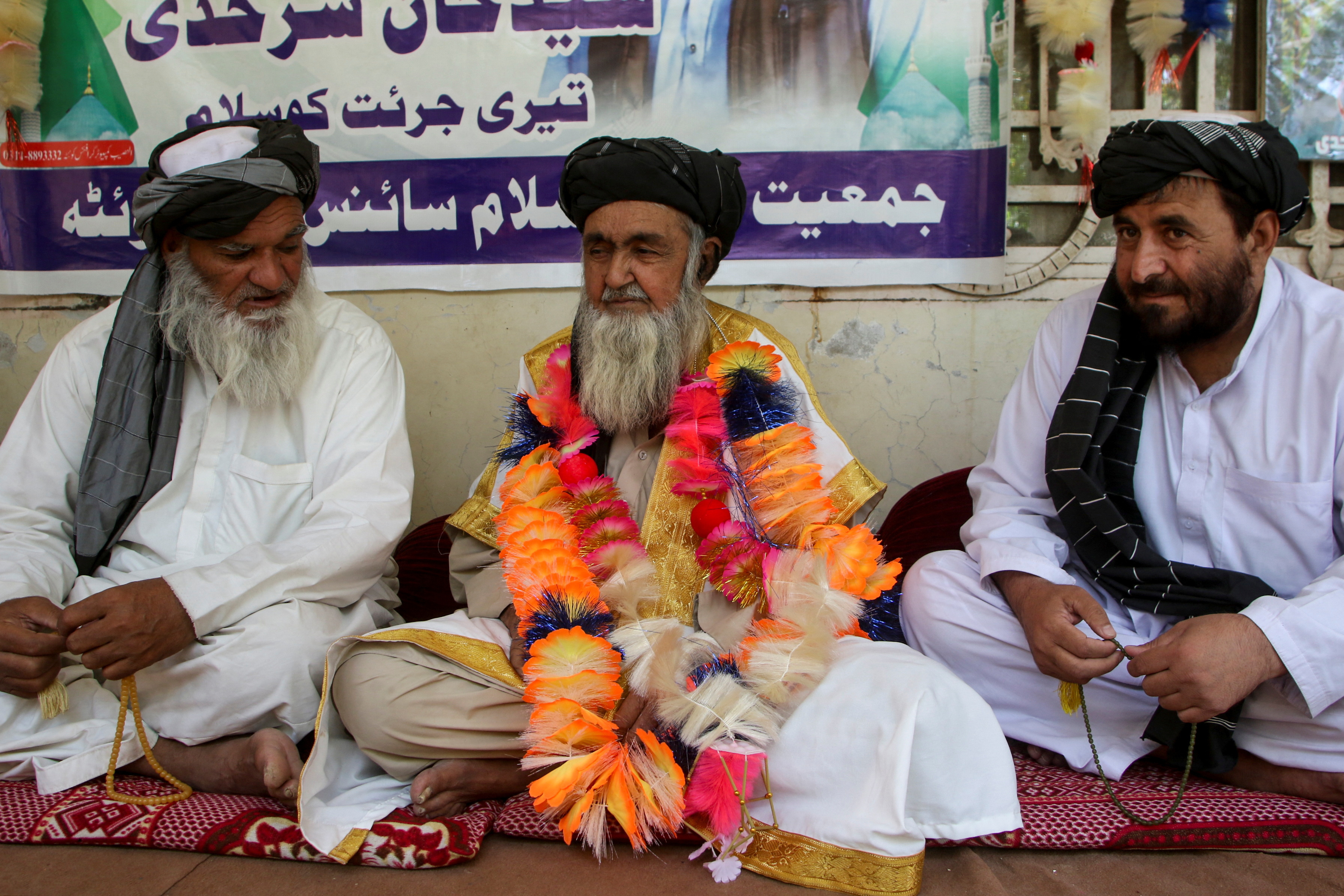 Father of a police officer who opened fire and killed a man in custody on blasphemy allegations, sits at his residence in Quetta