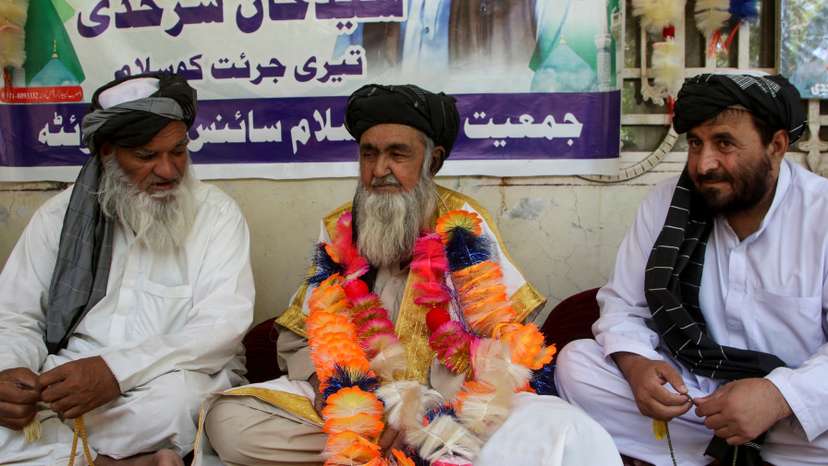Father of a police officer who opened fire and killed a man in custody on blasphemy allegations, sits at his residence in Quetta