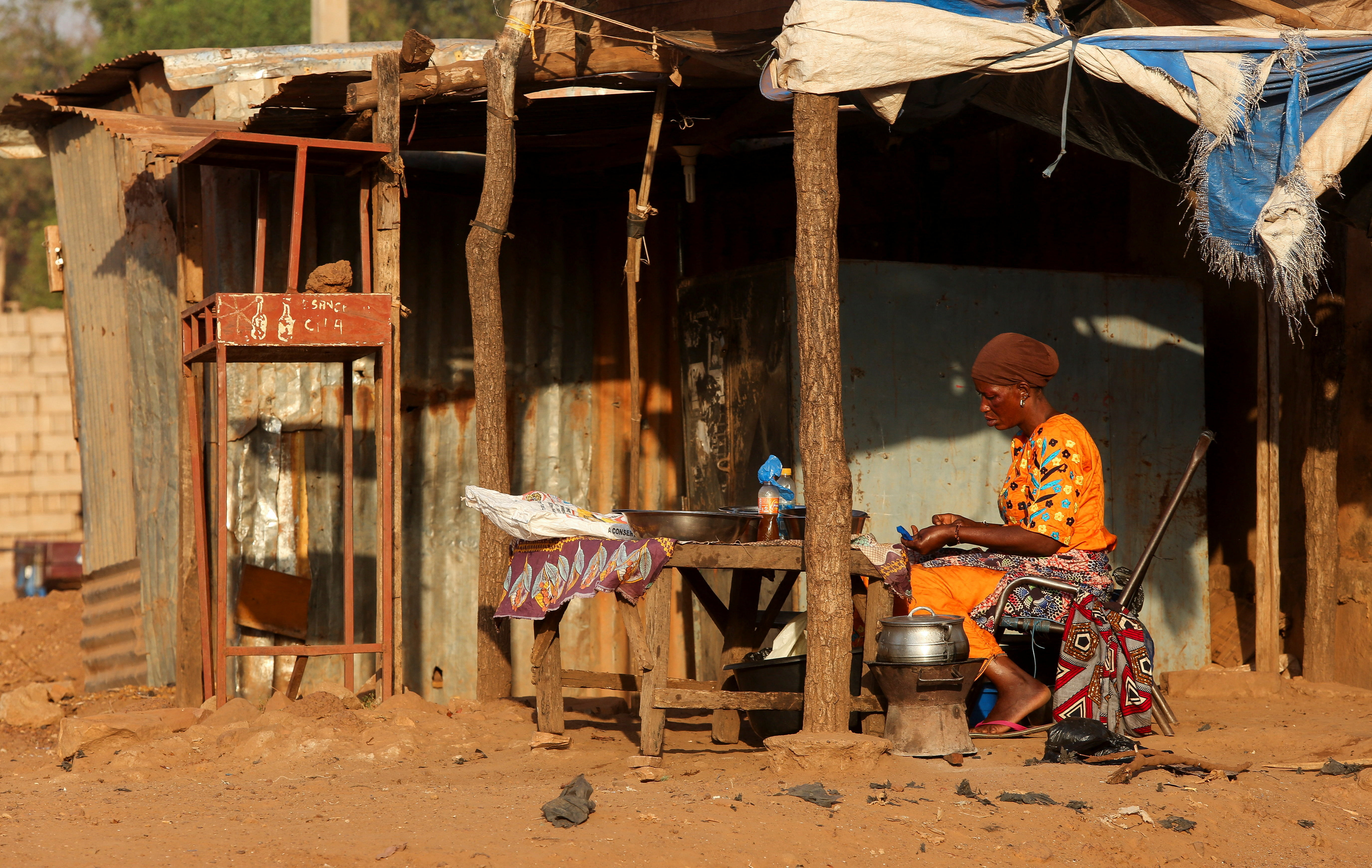 A woman prepares food on the road side in Bamako, Mali