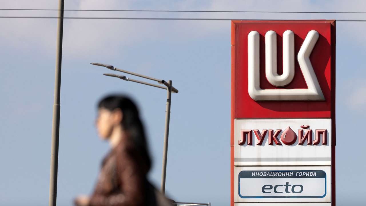 Woman walks near a Lukoil gas station in Sofia