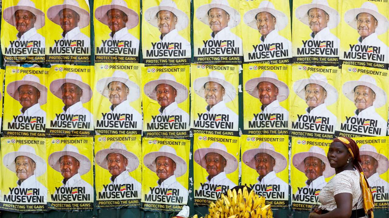 Women sell bananas near campaign posters of Uganda's President and the leader of ruling NRM party, Yoweri Museveni, following the general elections in Kampala,