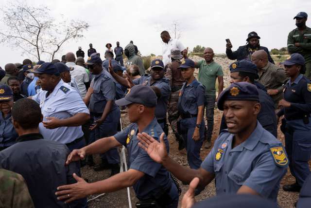 South African police in standoff with hundreds of illegal miners in disused shaft