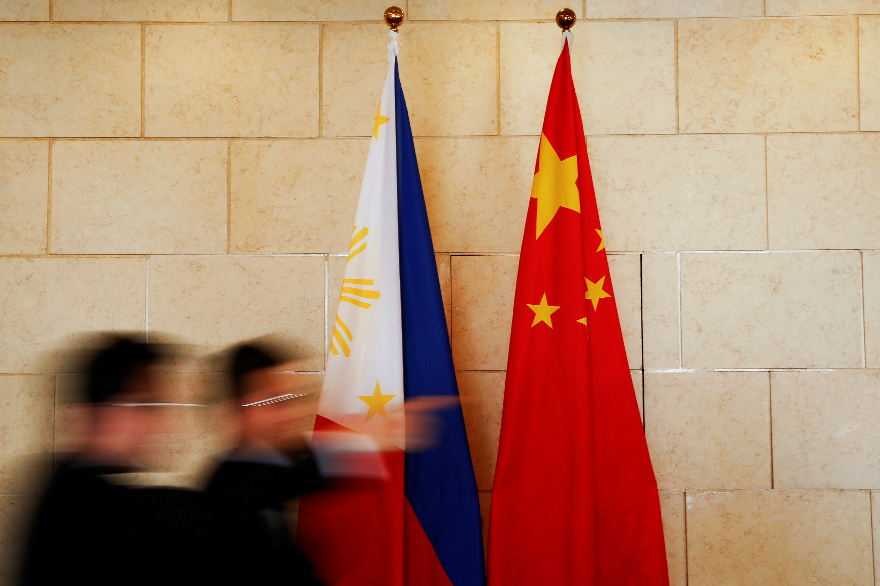 FILE PHOTO: National flags are placed outside a room where Philippine Finance Secretary Carlos Dominguez and China's Commerce Minister Gao Hucheng address reporters after their meeting in Beijing
