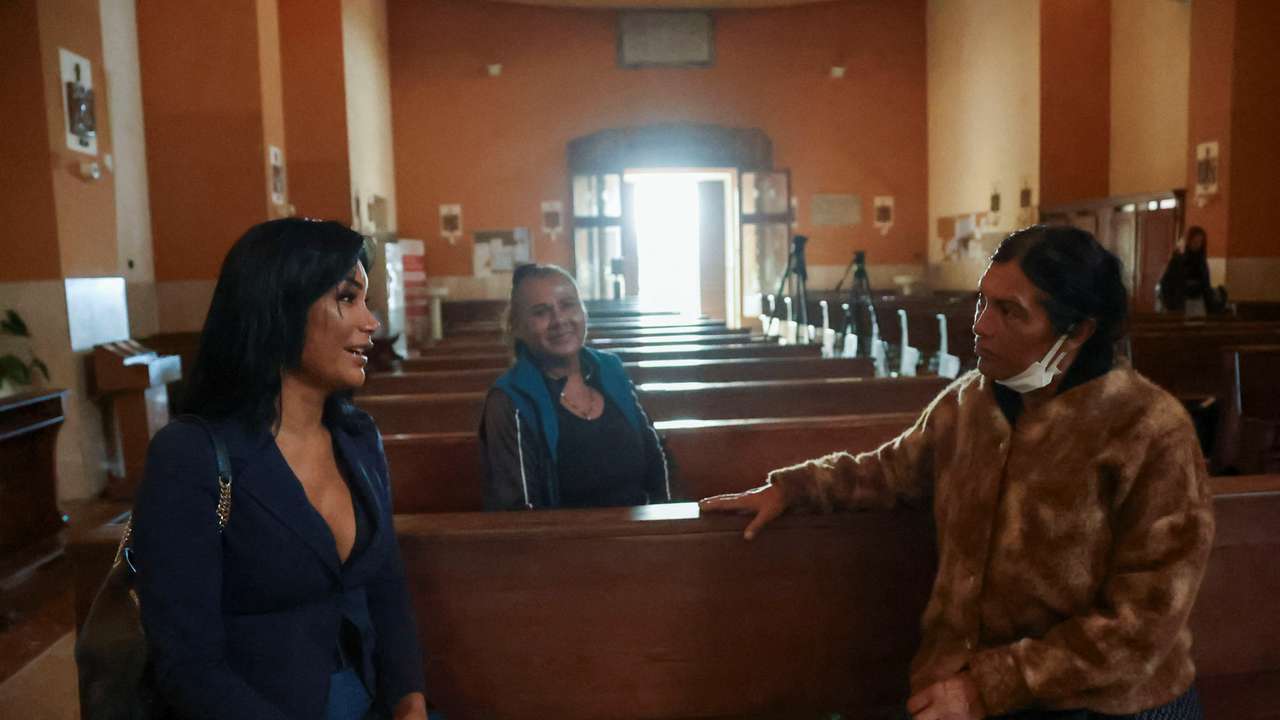 Carla and Claudia Victoria sit inside the Blessed Immaculate Virgin Church in Torvaianica