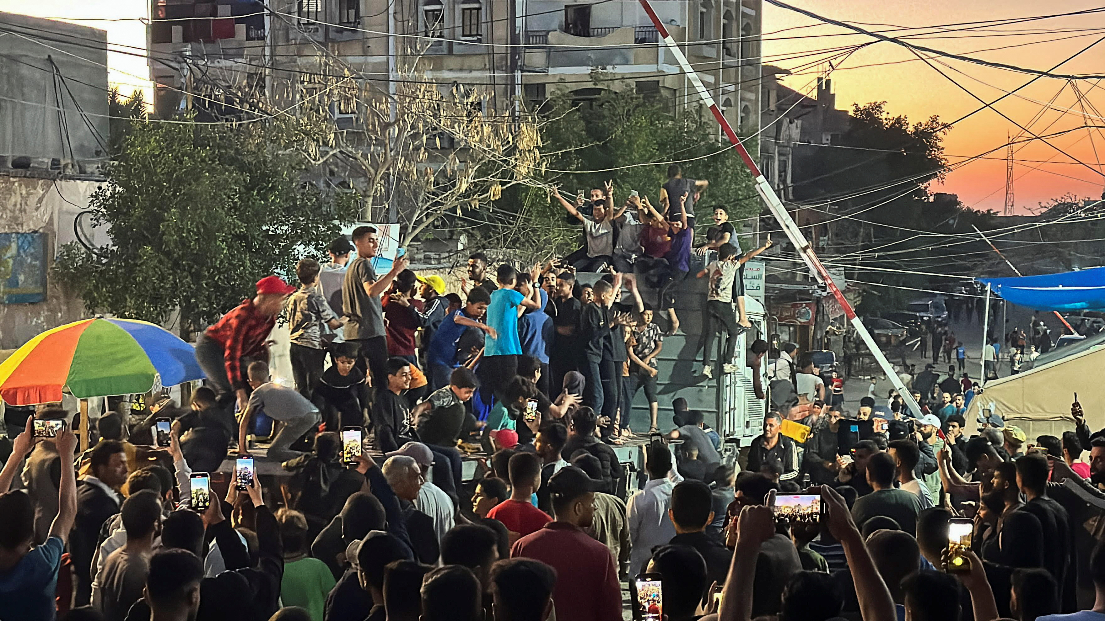 Palestinians react after Hamas accepted a ceasefire proposal from Egypt and Qatar, in Rafah