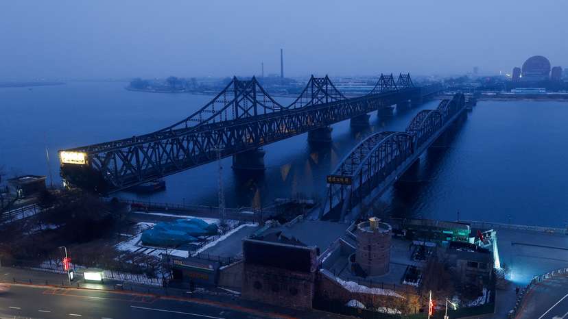 The Friendship Bridge and Broken Bridge over the Yalu River, which separates North Korea's Sinuiju from China, are seen before sunrise in Dandong