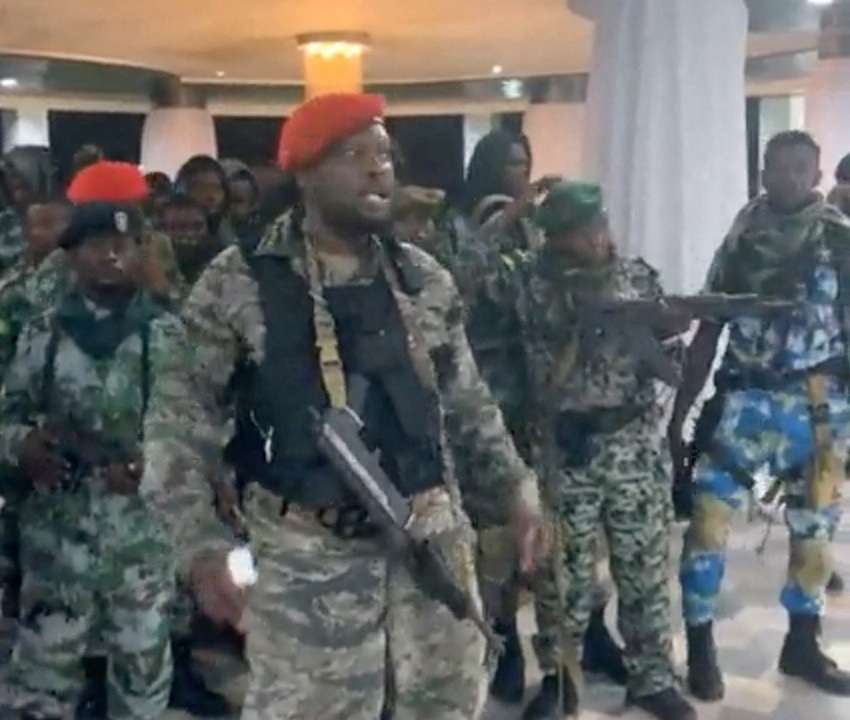 A man in military fatigues speaks inside the Palace of the Nation during an attempted coup in Kinshasa