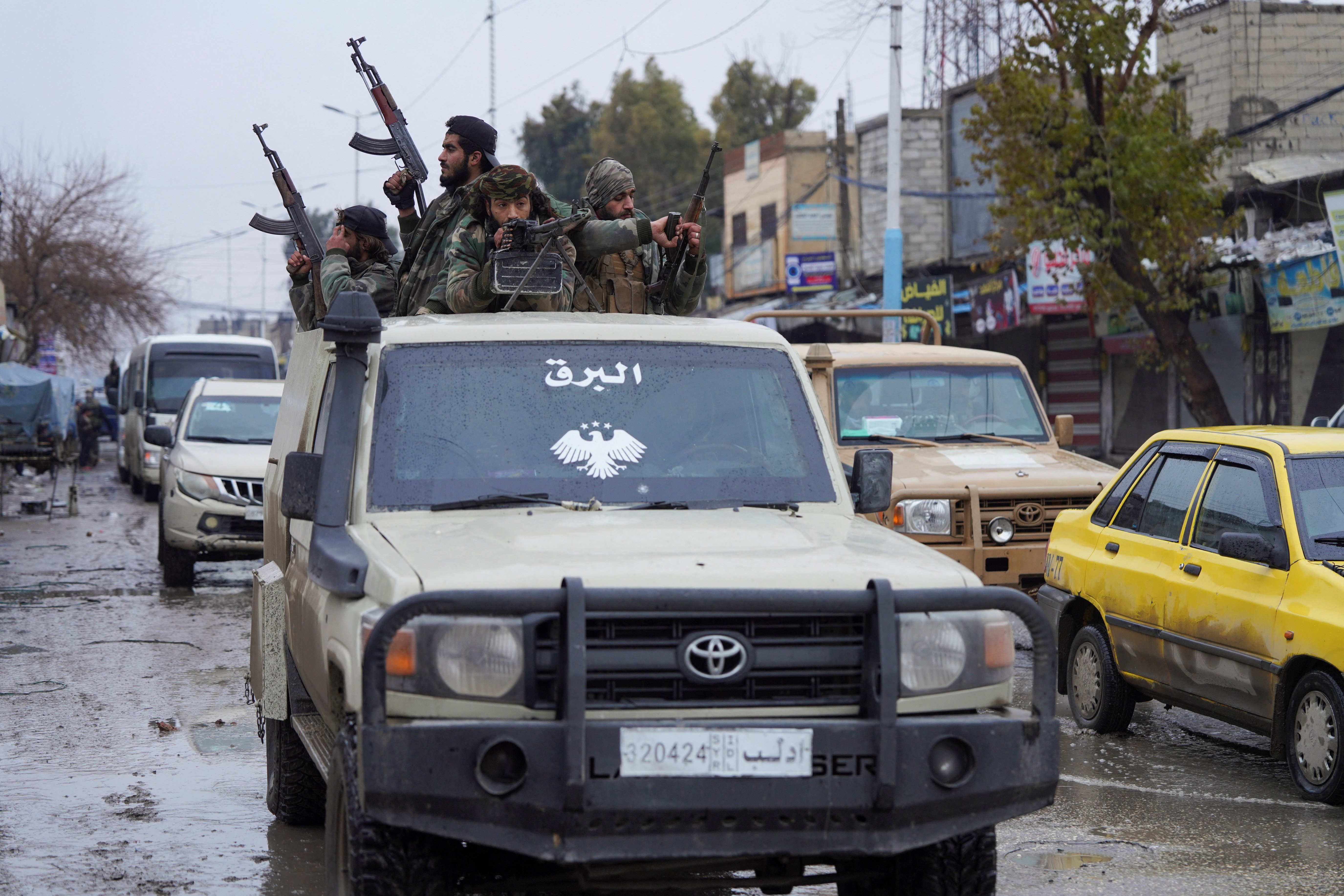 Syrian army military vehicles travel inside the city of Tabqa, after the withdrawal of the Syrian Democratic Forces (SDF)