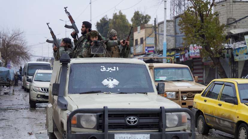 Syrian army military vehicles travel inside the city of Tabqa, after the withdrawal of the Syrian Democratic Forces (SDF)