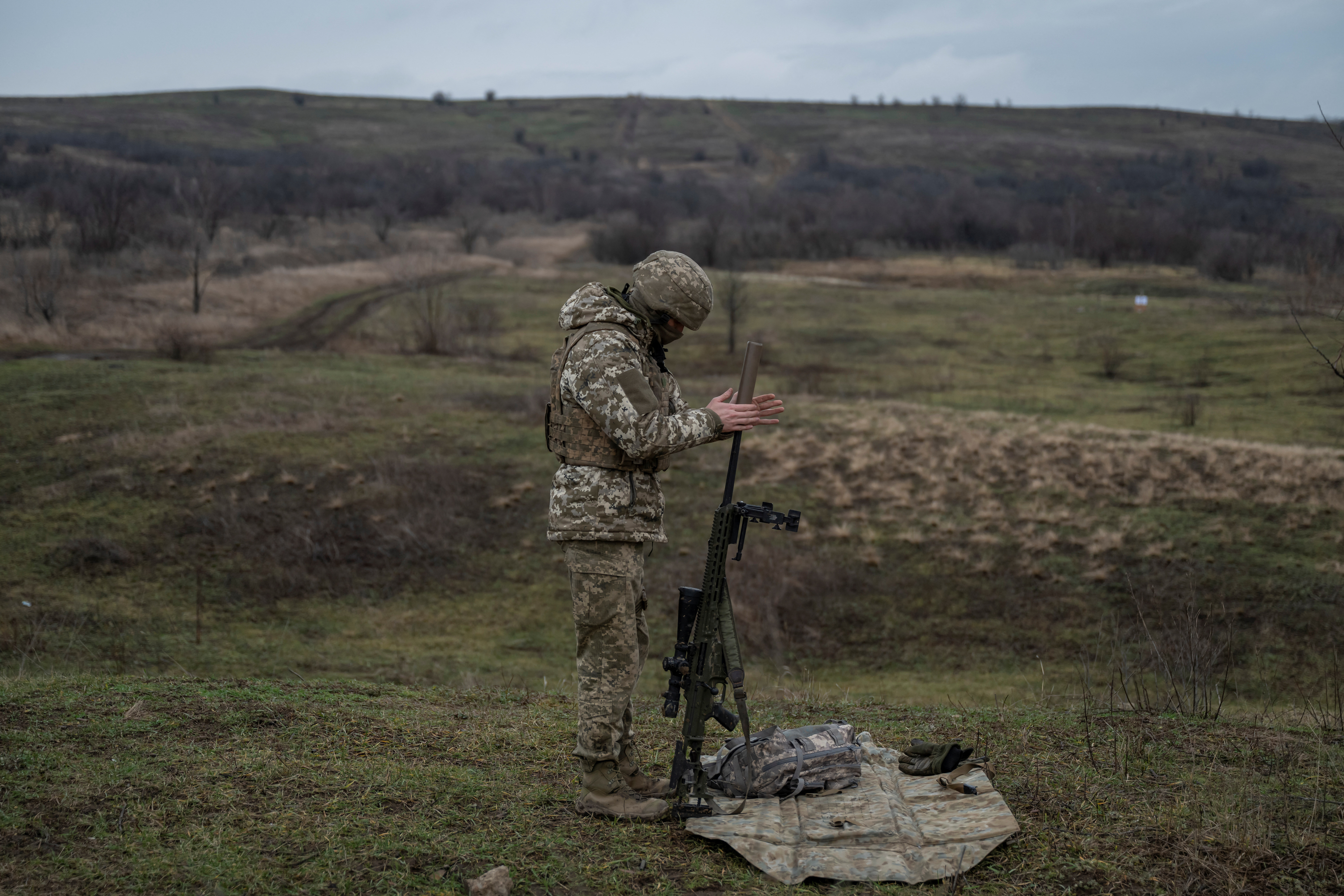 FILE PHOTO: Ukrainian Army sniper prepares his rifle at a shooting ground near a front line in Donetsk region