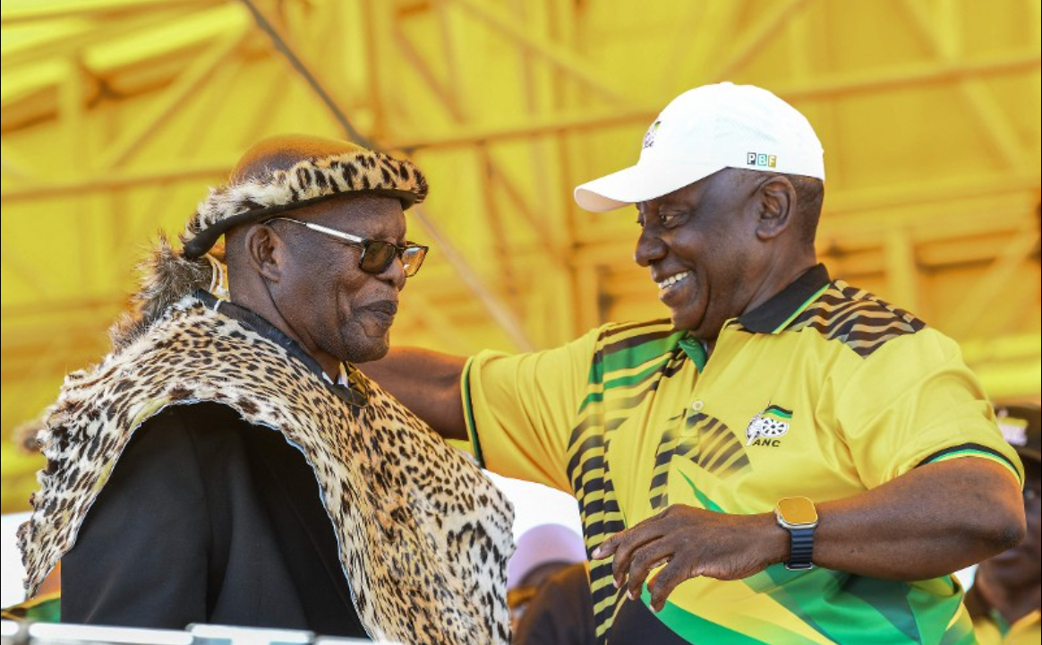South African President and President of the ruling African National Congress (ANC) Cyril Ramaphosa (R) presents an honorary leopard skin to veteran party member Benson Fihla (L) during the ANC’s 113th anniversary celebrations at a large open field in the Khayelitsha area of Cape Town on January 11, 2025.