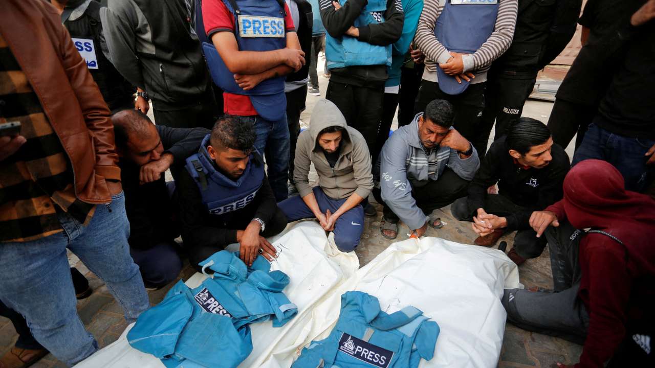 Palestinians mourn local journalists Hassouna Sleem and Sary Mansour, who were killed in an Israeli strike on a house, at a hospital in the central Gaza Strip
