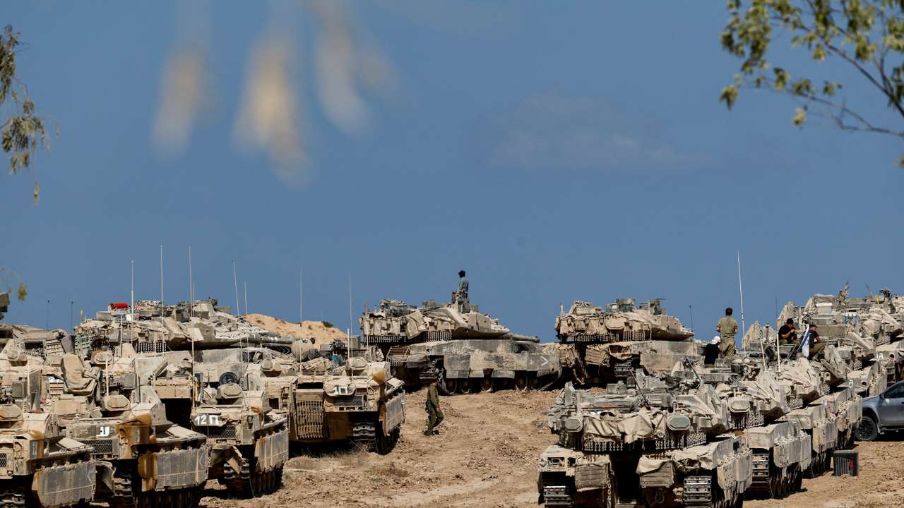 Israeli soldiers, tanks and armoured personnel carriers (APCs) near the Israel-Gaza border