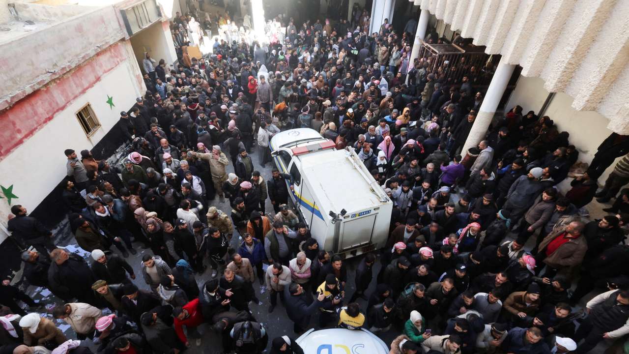 Members of the Syrian civil defence group search Sednaya prison
