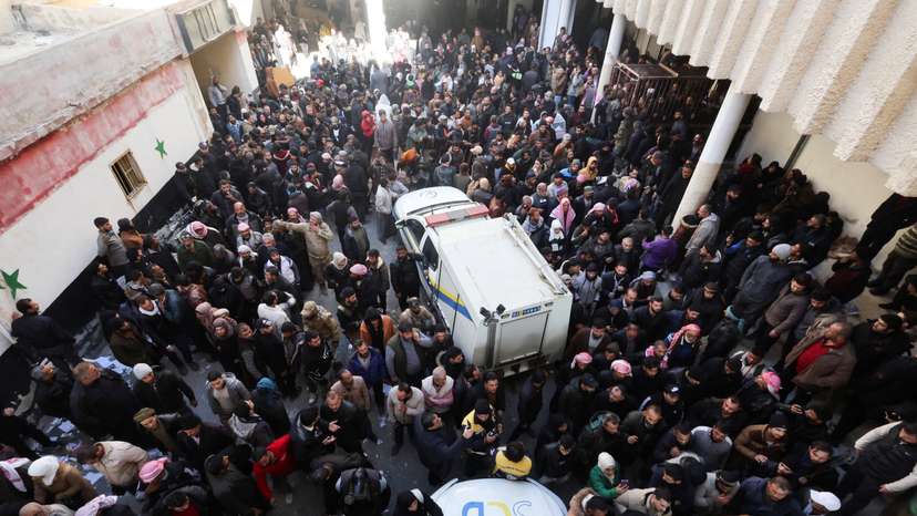 Members of the Syrian civil defence group search Sednaya prison