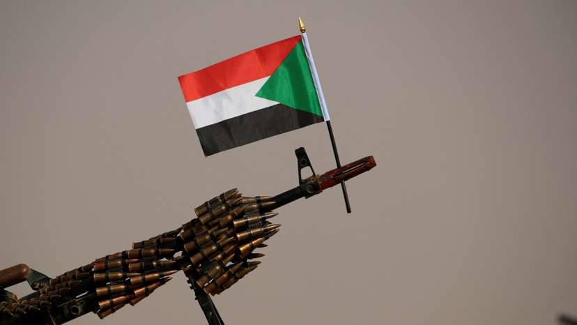 A Sudanese national flag is attached to a machine gun of Paramilitary Rapid Support Forces (RSF) soldiers as they wait for the arrival of Lieutenant General Mohamed Hamdan Dagalo before a meeting