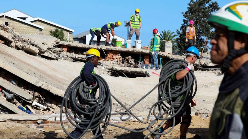 FILE PHOTO: Rescuers work to rescue construction workers trapped under a building that collapsed in George