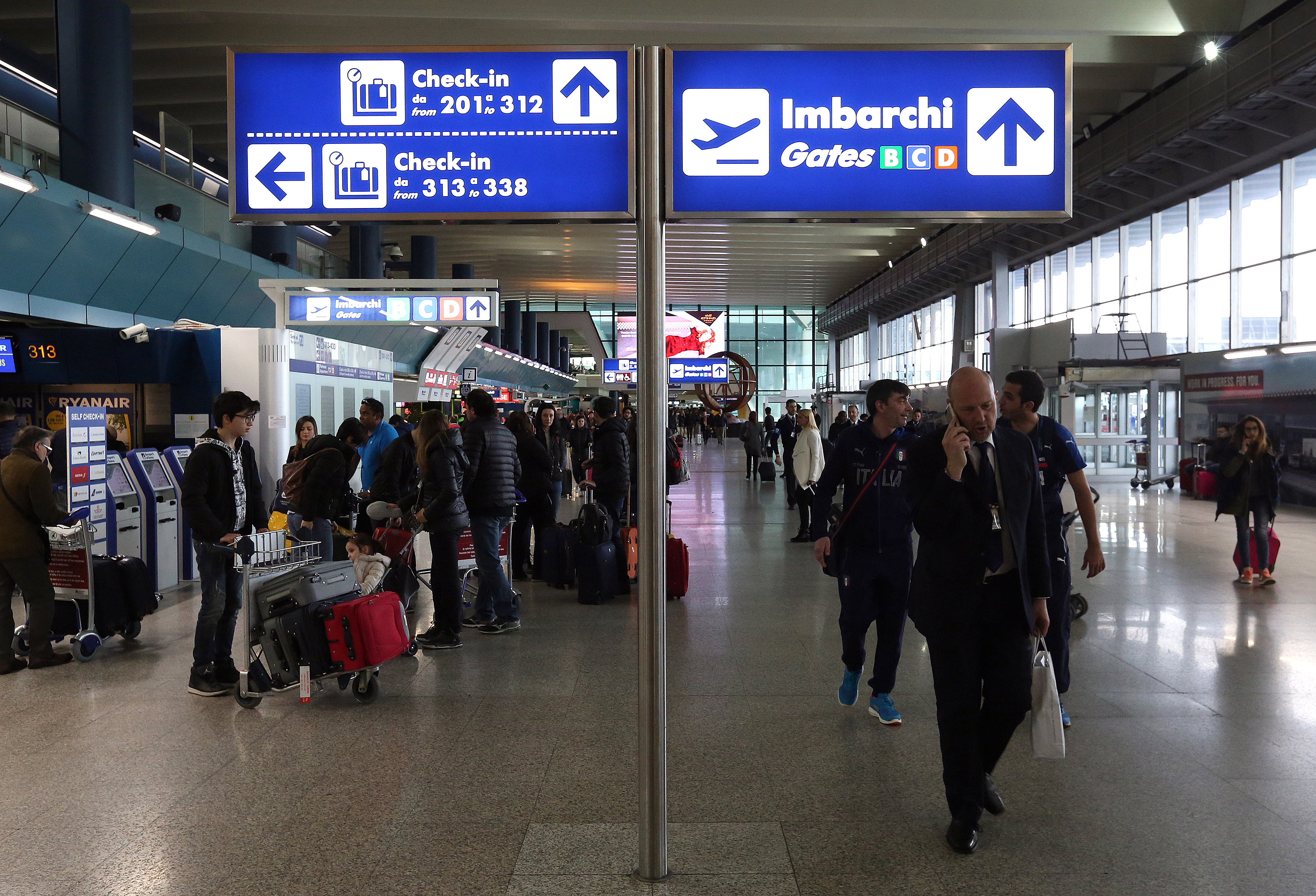 Check-in and  departure gates signs are seen at the terminal at Fiumicino's International airport near Rome