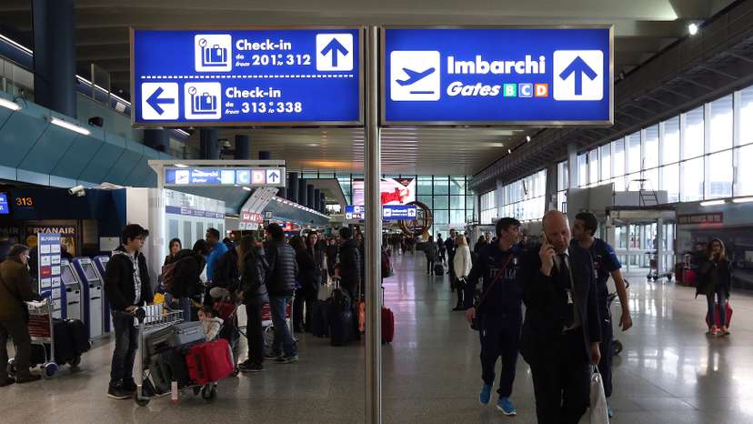 Check-in and departure gates signs are seen at the terminal at Fiumicino's International airport near Rome