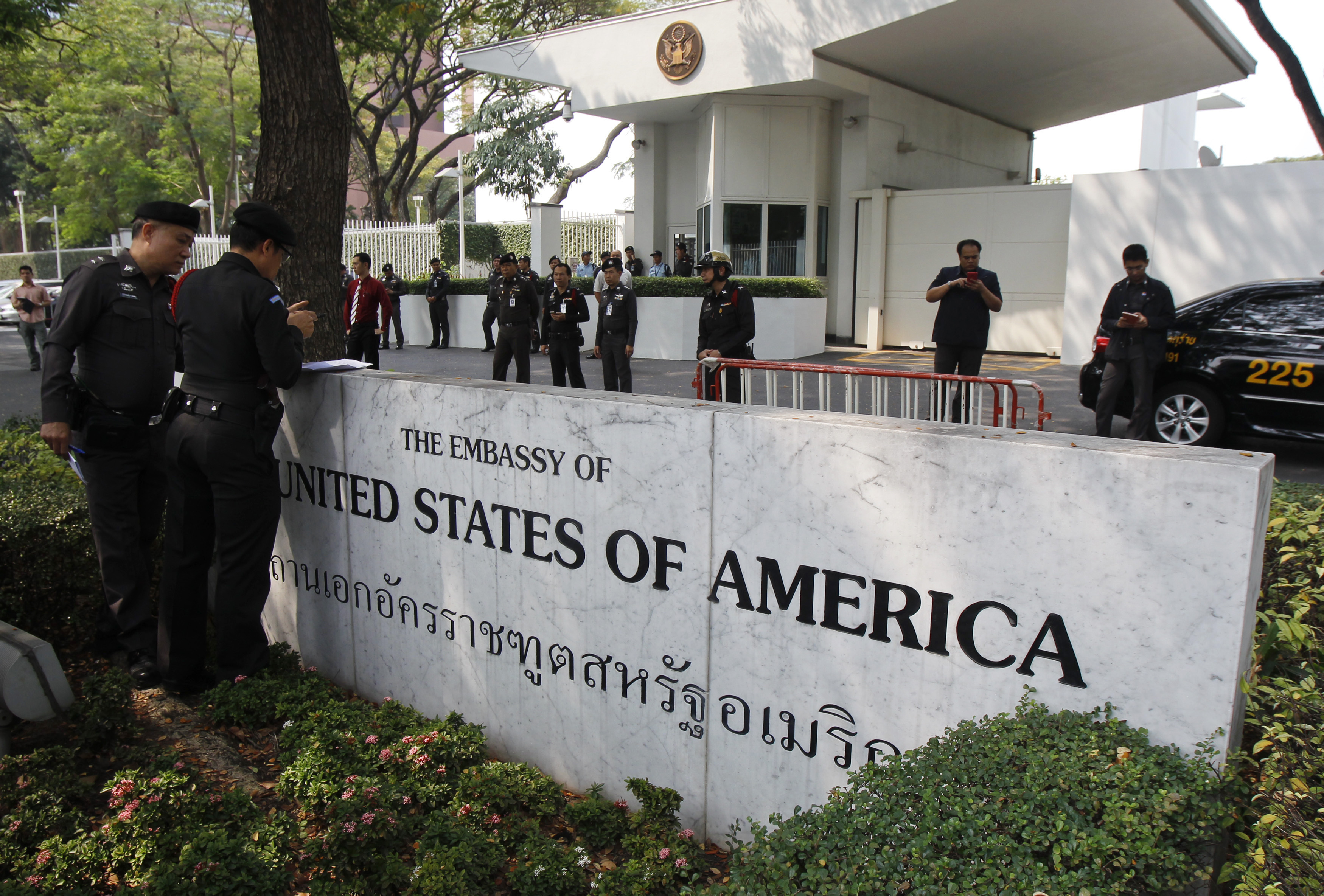 Police stand guard outside the U.S. embassy in Bangkok