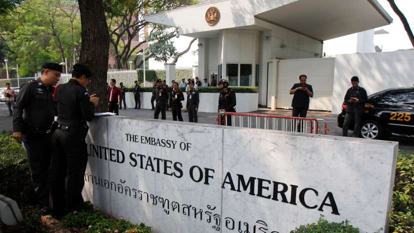 Police stand guard outside the U.S. embassy in Bangkok