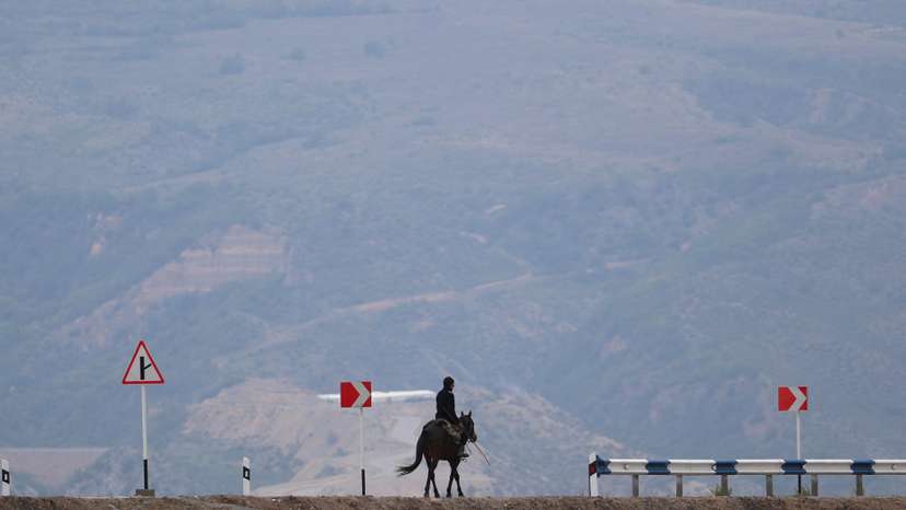 A man rides a horse near the Armenia-Azerbaijan border