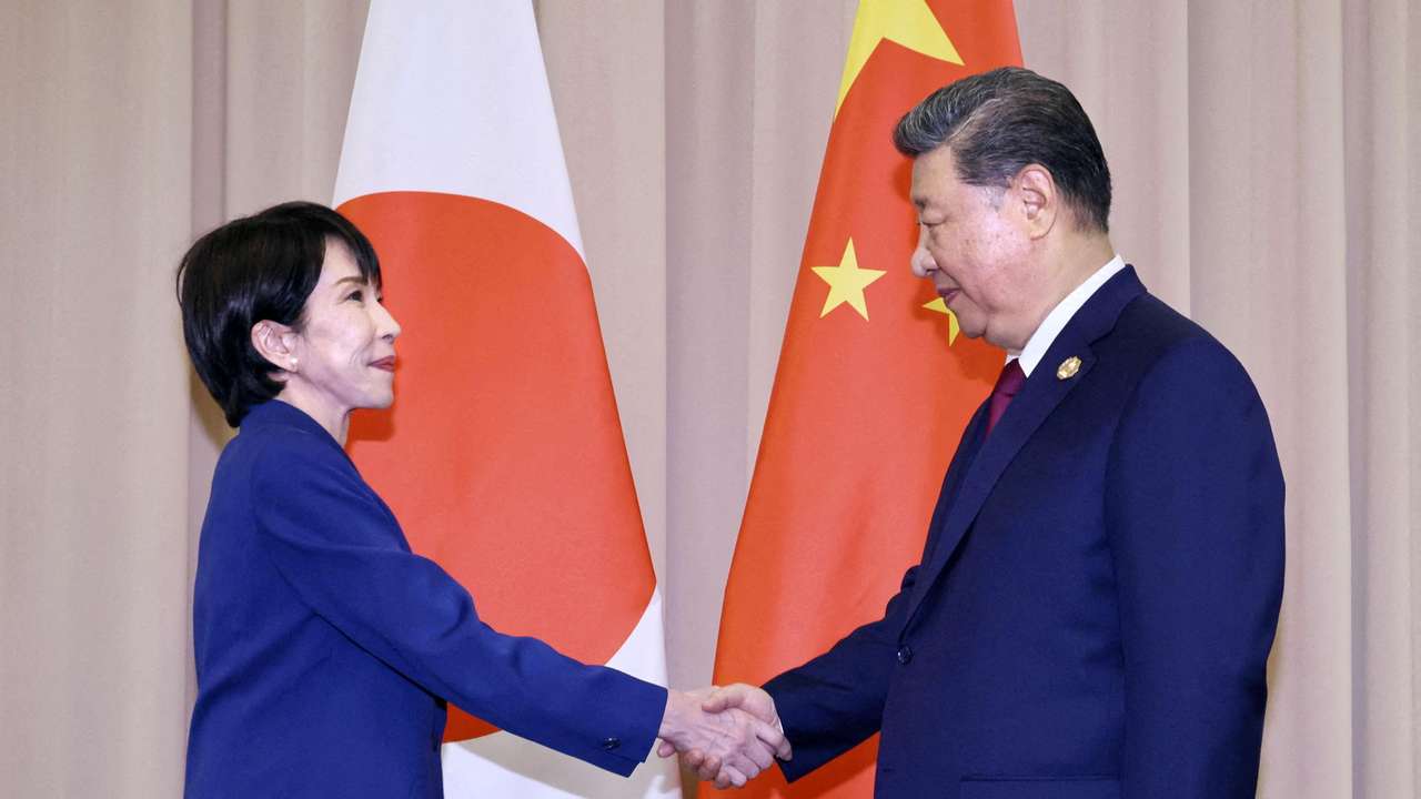 FILE PHOTO: Japanese Prime Minister Sanae Takaichi shakes hands with Chinese President Xi Jinping ahead of their talks in Gyeongju, South Korea