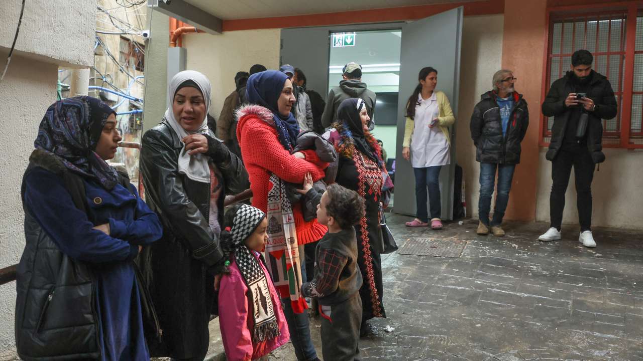 Palestinians queue at a UNRWA health center inside Burj al-Barajneh refugee camp in Beirut