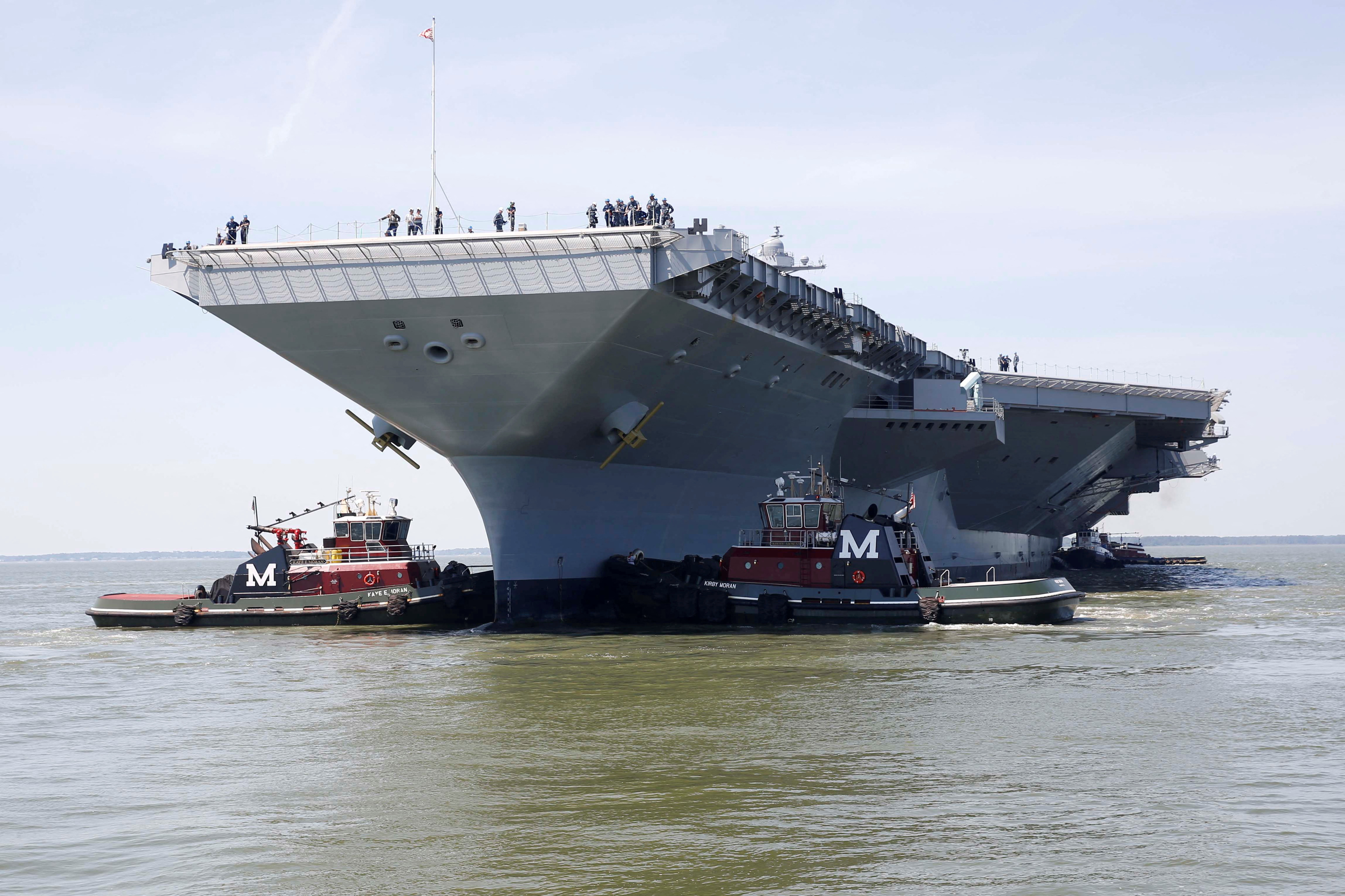 FILE PHOTO: Pre-Commissioning Unit Gerald R. Ford is maneuvered by tug boats in the James River