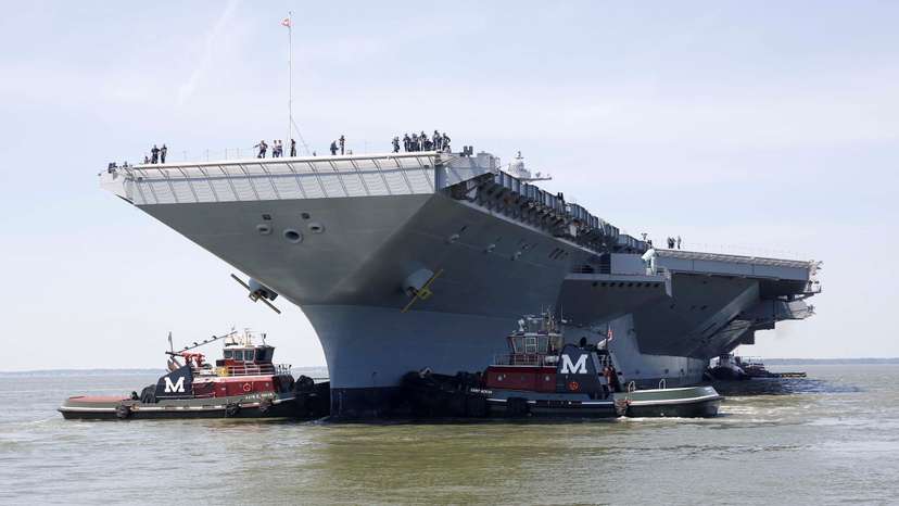 FILE PHOTO: Pre-Commissioning Unit Gerald R. Ford is maneuvered by tug boats in the James River
