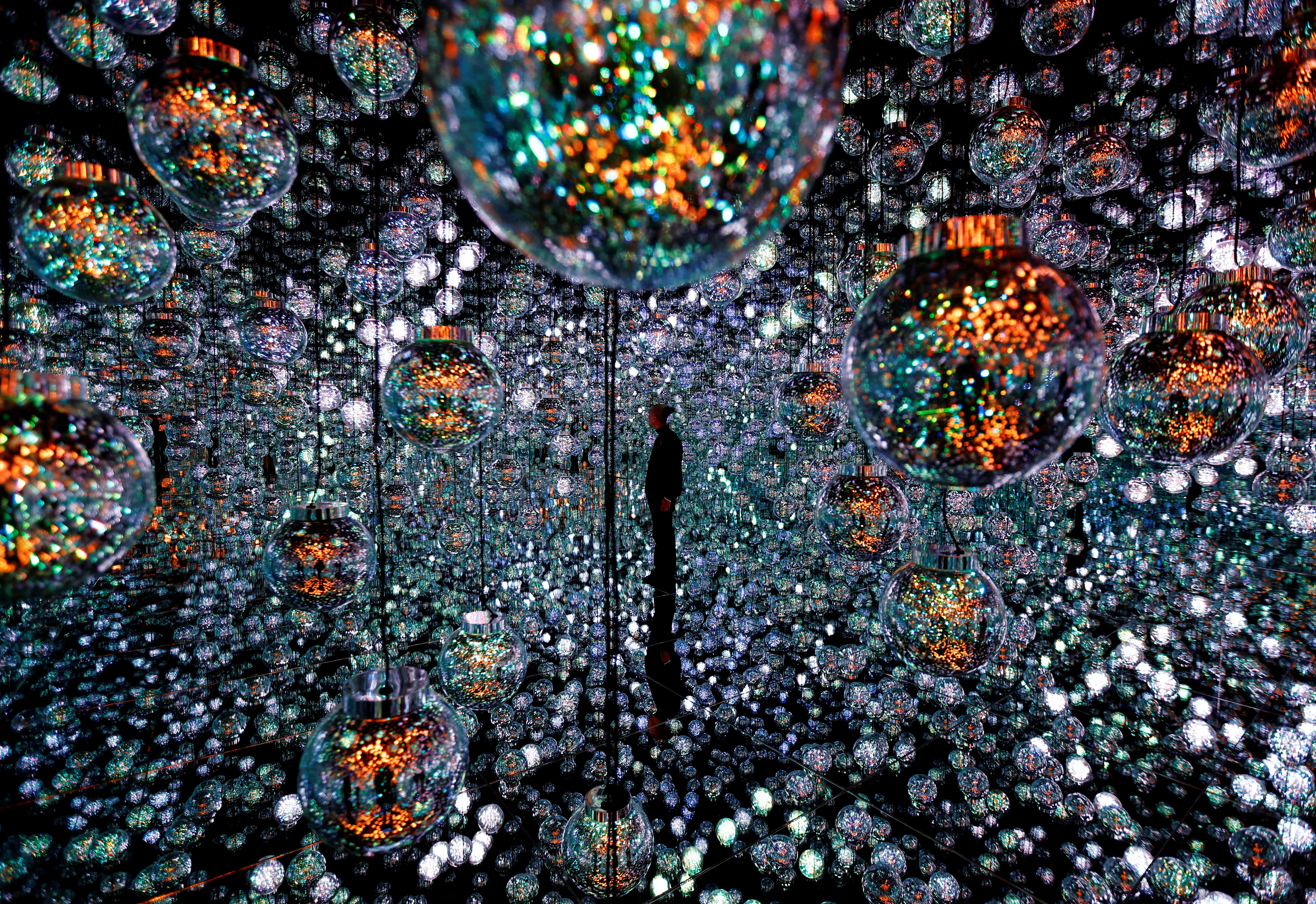 A member of the teamLab digital art group poses in an installation in preparation for the reopening of their Borderless museum in February at the Azabudai Hills complex in Tokyo