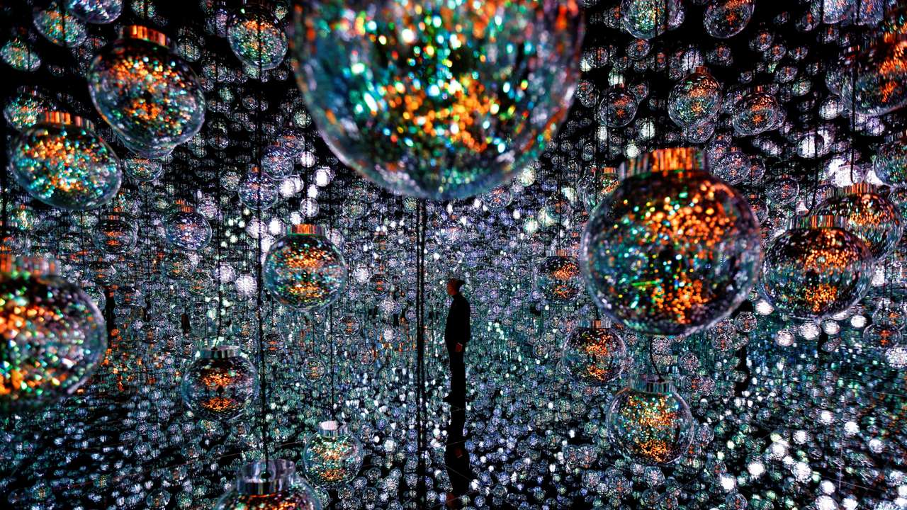A member of the teamLab digital art group poses in an installation in preparation for the reopening of their Borderless museum in February at the Azabudai Hills complex in Tokyo