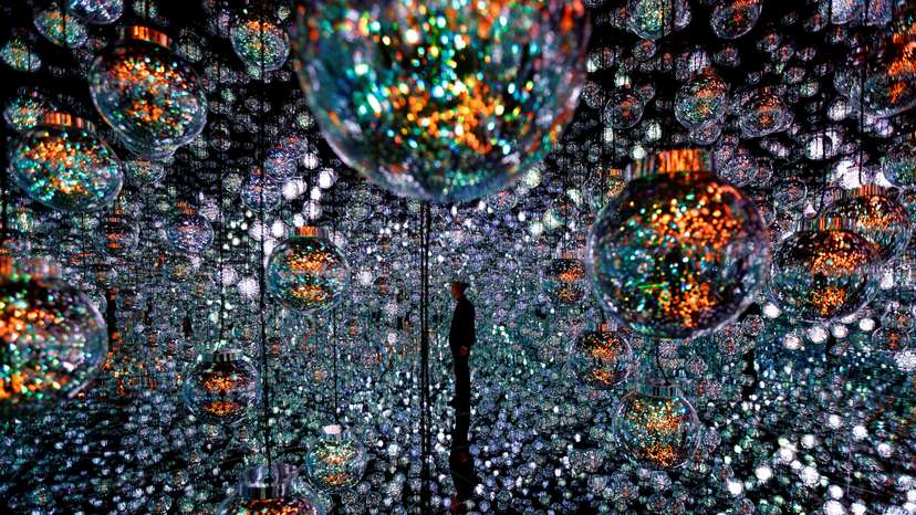 A member of the teamLab digital art group poses in an installation in preparation for the reopening of their Borderless museum in February at the Azabudai Hills complex in Tokyo