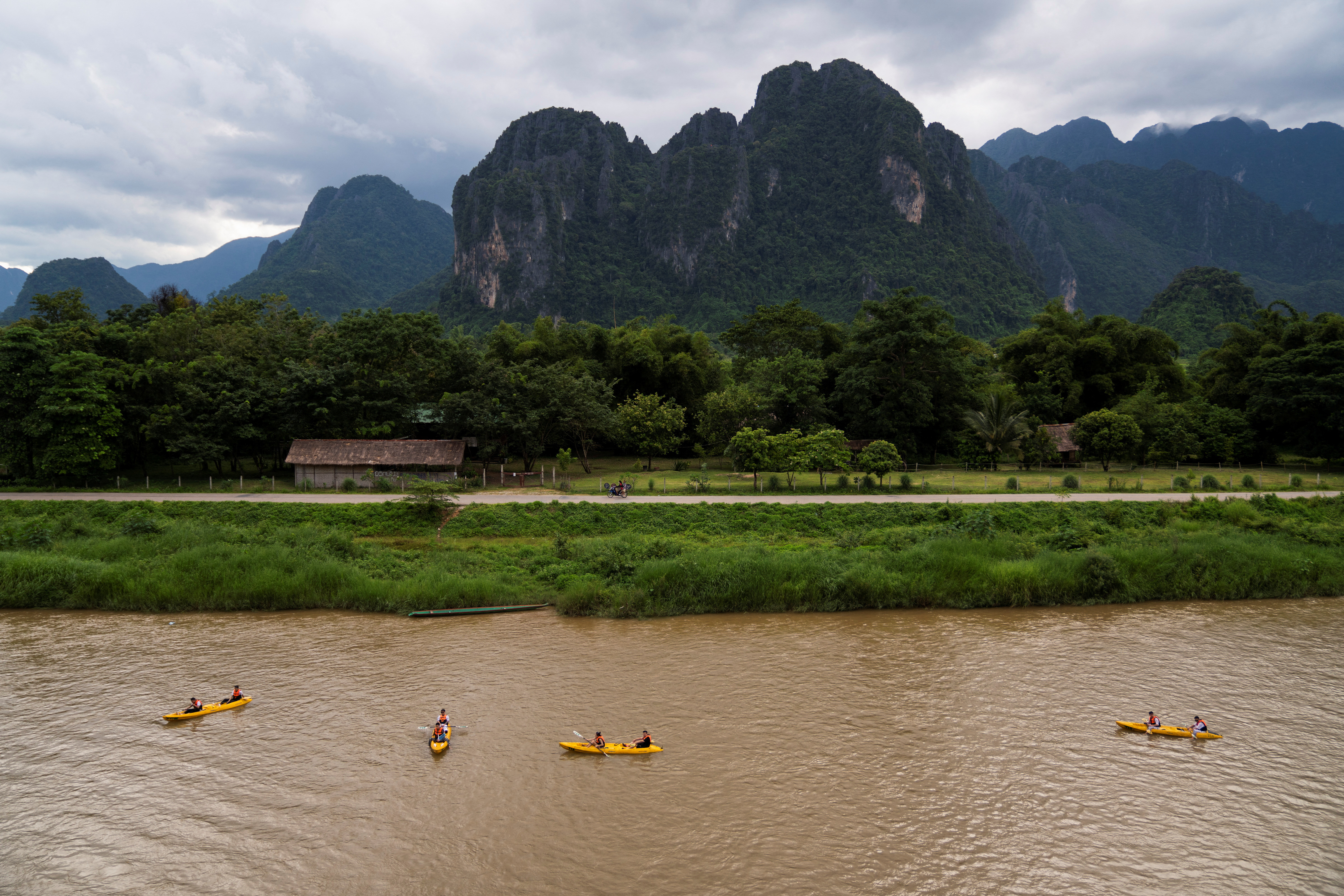 FILE PHOTO: Tourists use kayaks on the river in Vang Vieng