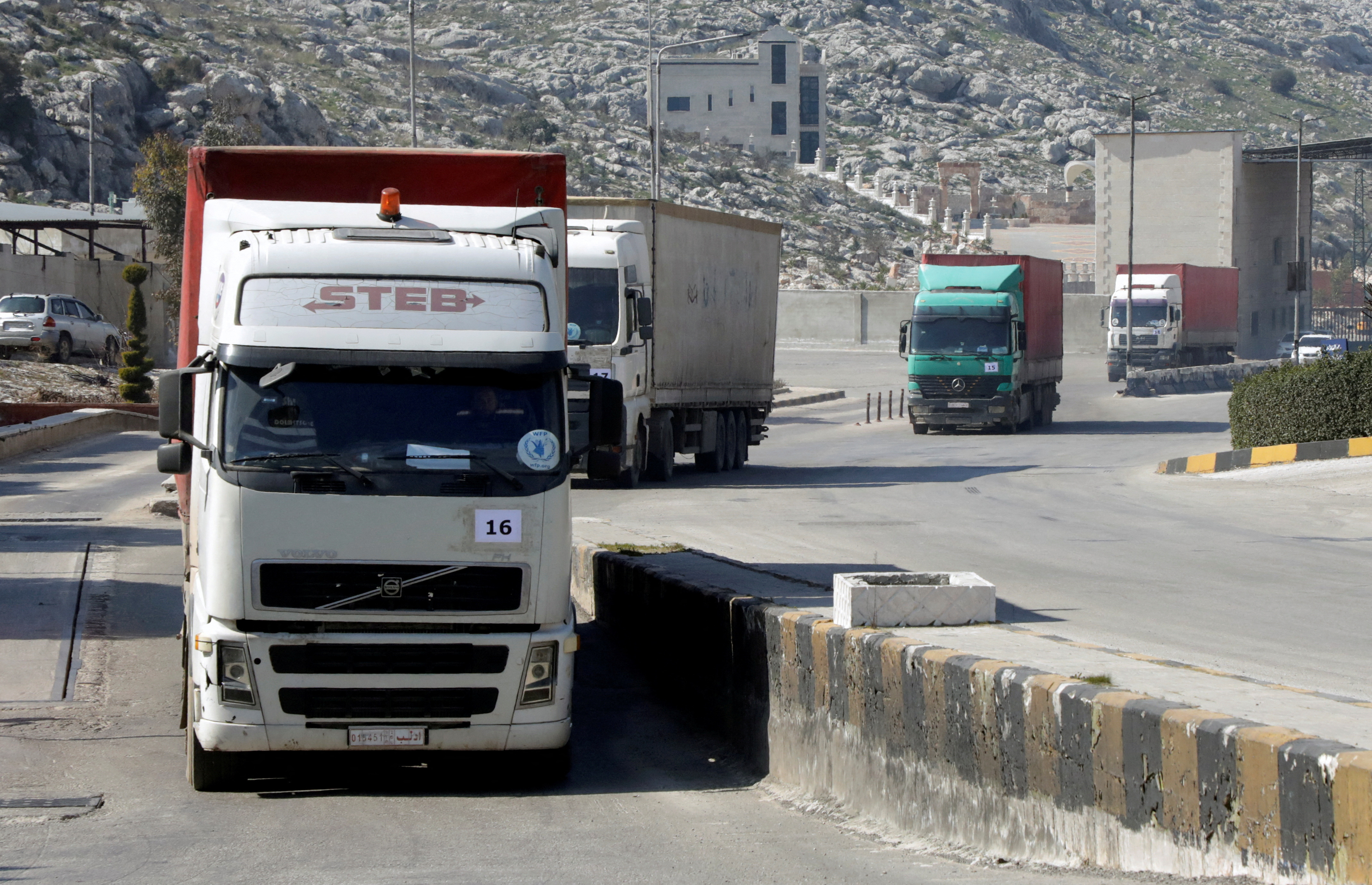 FILE PHOTO: A convoy of trucks carrying aid from UN World Food Programme (WFP) enters Bab al-Hawa crossing