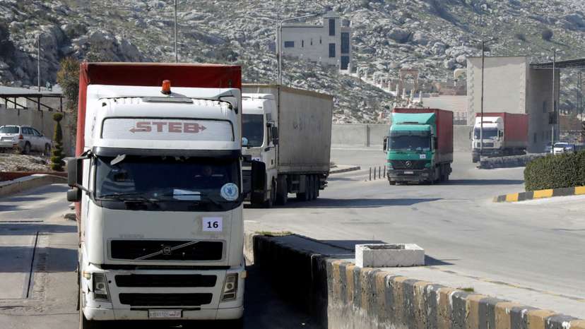 FILE PHOTO: A convoy of trucks carrying aid from UN World Food Programme (WFP) enters Bab al-Hawa crossing