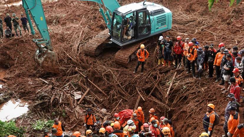 Indonesian rescue members search for victims at the site of a landslide, which hit Cibeunying village on November 13, in Cilacap