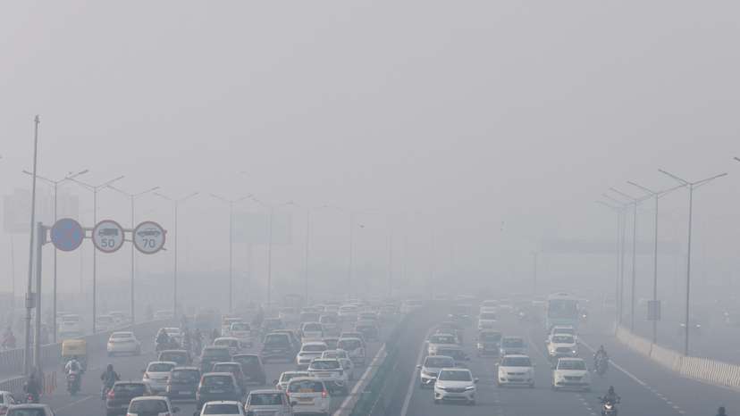 Traffic moves along a highway shrouded in heavy smog in New Delhi