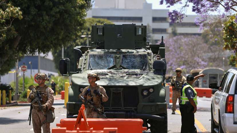 FILE PHOTO: U.S. Marines stand watch at a checkpoint as they guard a federal building, in Los Angeles