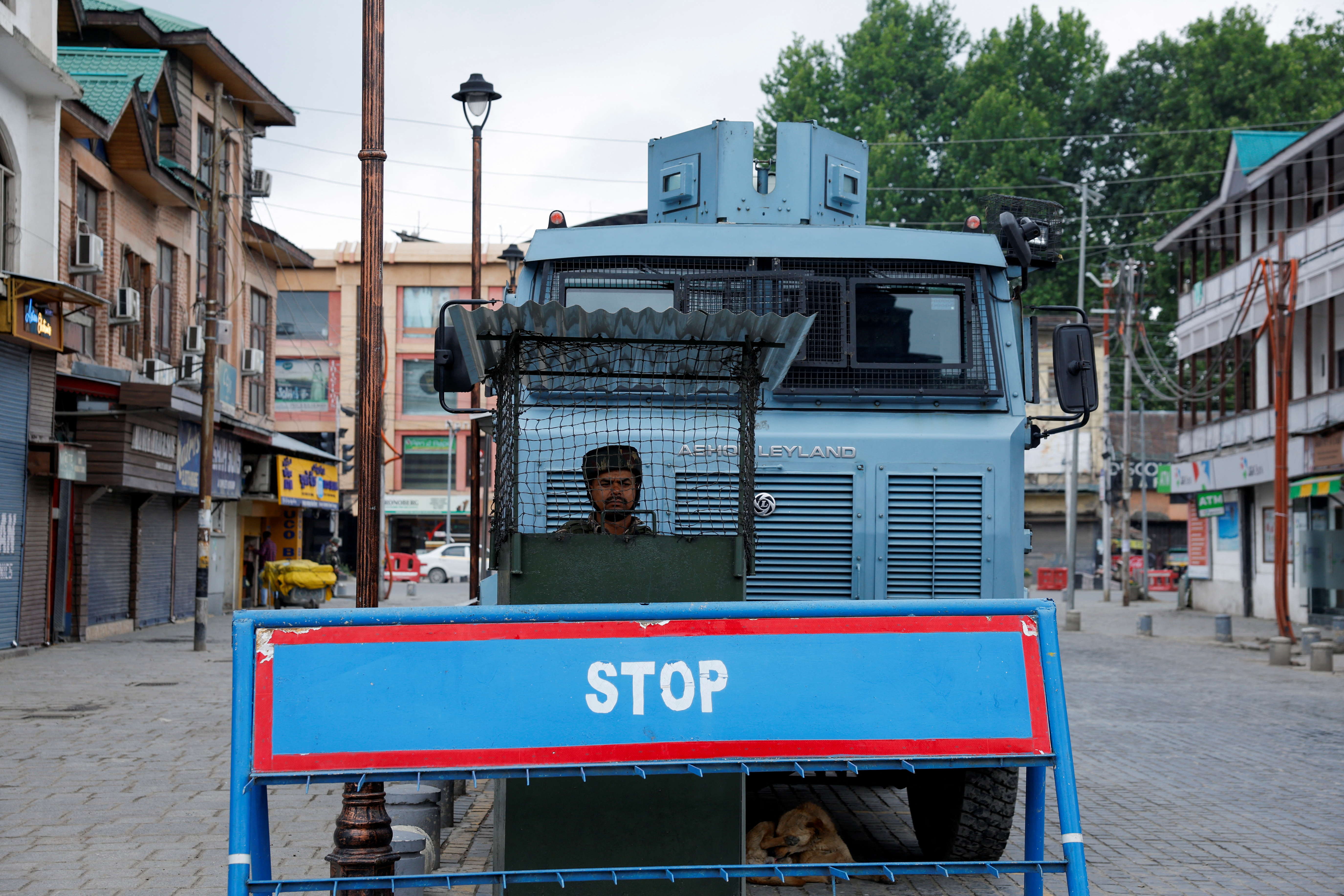An Indian security personnel stands guard on a street, following clashes between India and Pakistan, in Srinagar
