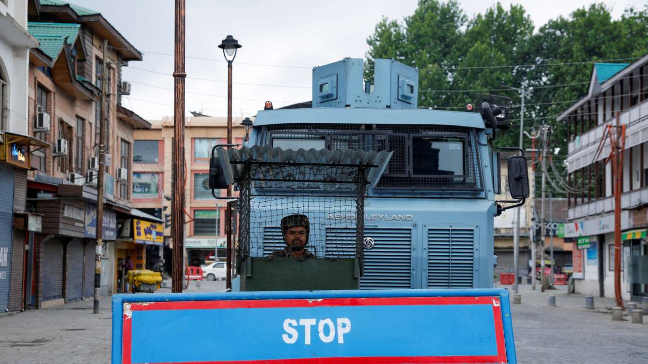 An Indian security personnel stands guard on a street, following clashes between India and Pakistan, in Srinagar